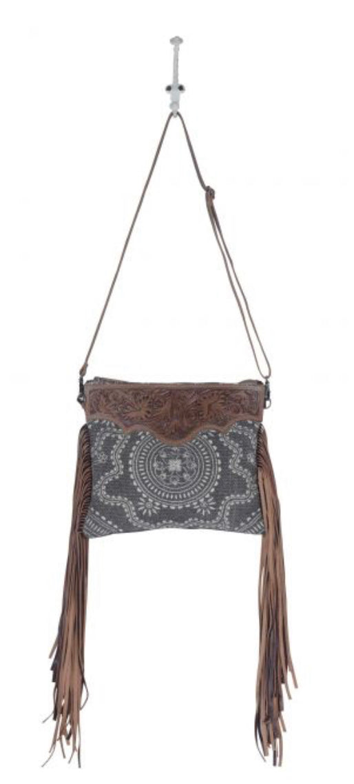 Monochromatic motif hand tooled bag