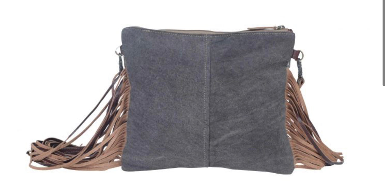 Monochromatic motif hand tooled bag
