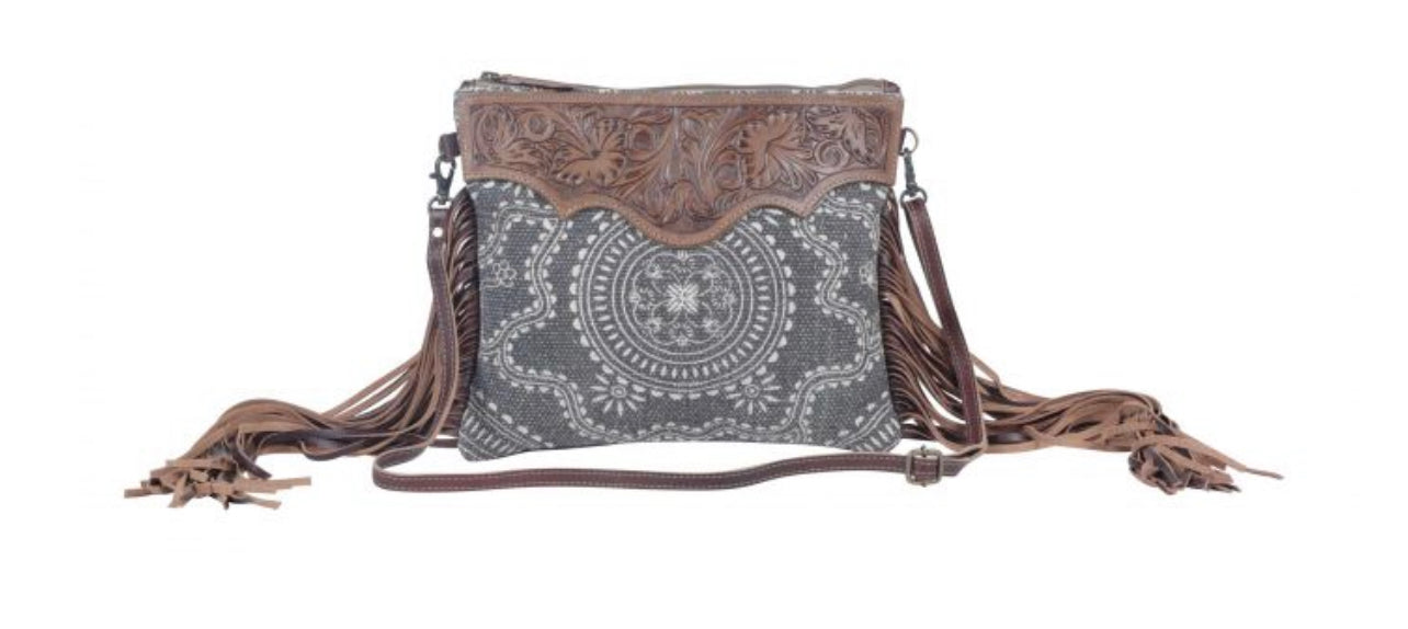 Monochromatic motif hand tooled bag