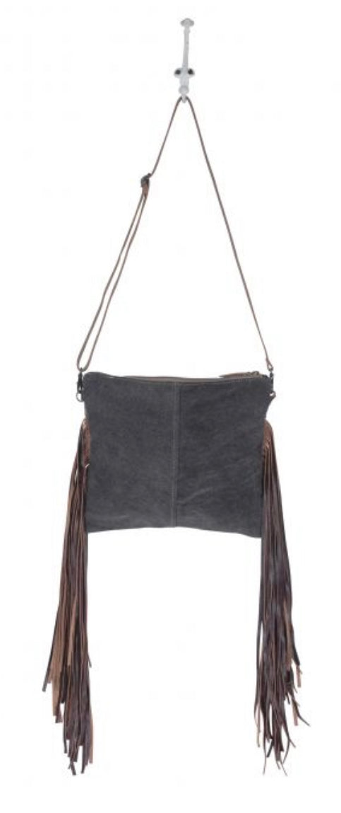 Monochromatic motif hand tooled bag