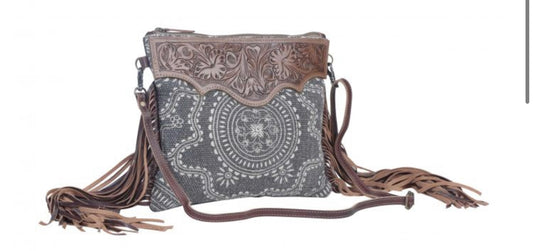 Monochromatic motif hand tooled bag