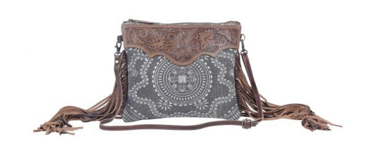 Monochromatic motif hand tooled bag
