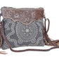Monochromatic motif hand tooled bag